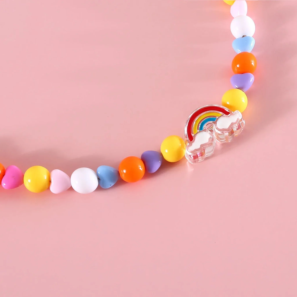 Colourful plastic bead pet necklace shown in peach, rainbow, and small flower patterns with an adjustable clasp.