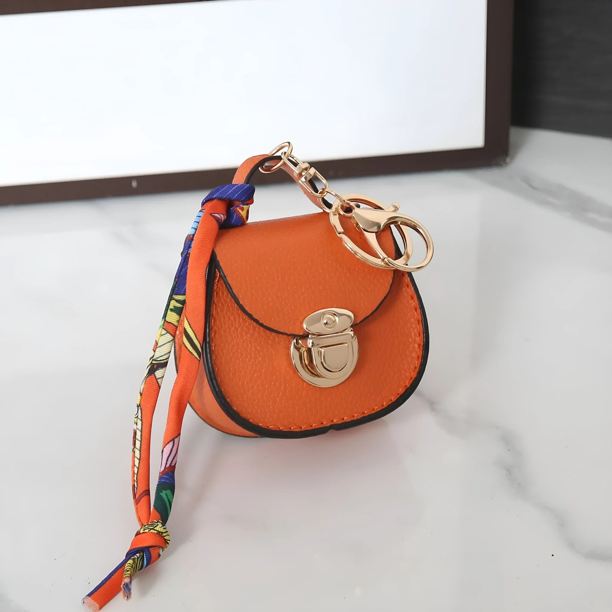 Small PVC coin purse with keychain in solid colour options including black, brown, orange, pink, red, and greige