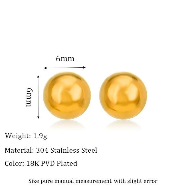 Close-up of a simple gold ball stud earring on a titanium steel post against a plain background.