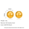Close-up of a simple gold ball stud earring on a titanium steel post against a plain background.