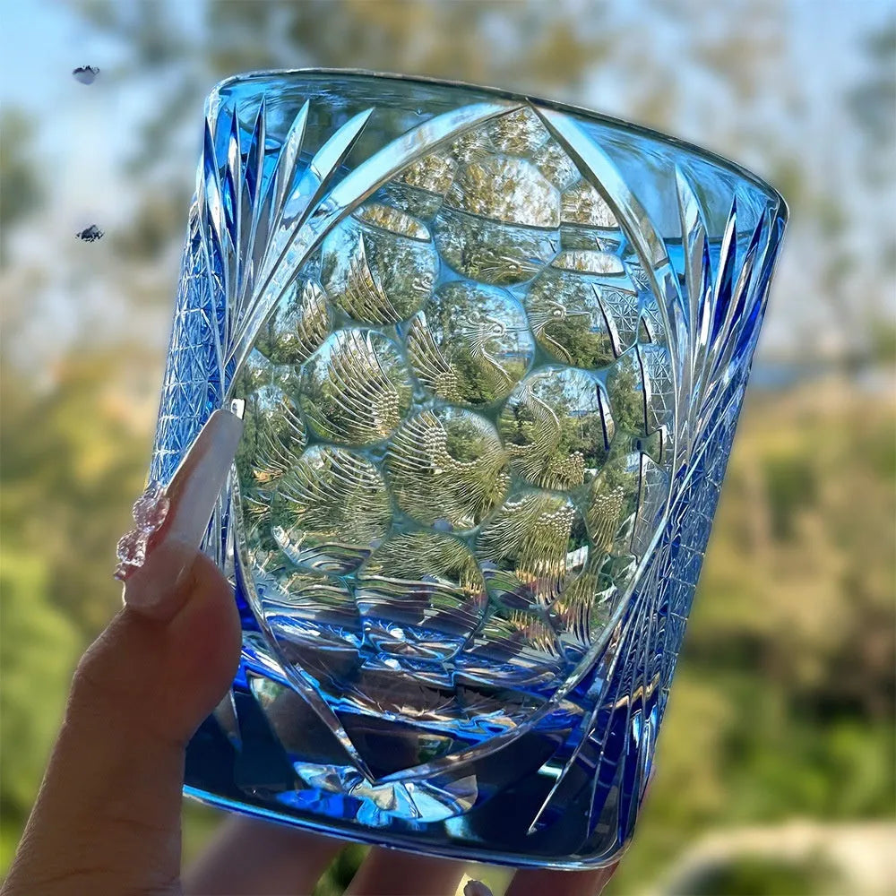 Hand carved crystal whiskey shot glass in sky blue with crane motif, 90x100mm