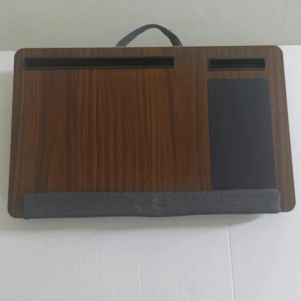 Foldable laptop desk in black walnut colour on a bed, showing open leg supports.