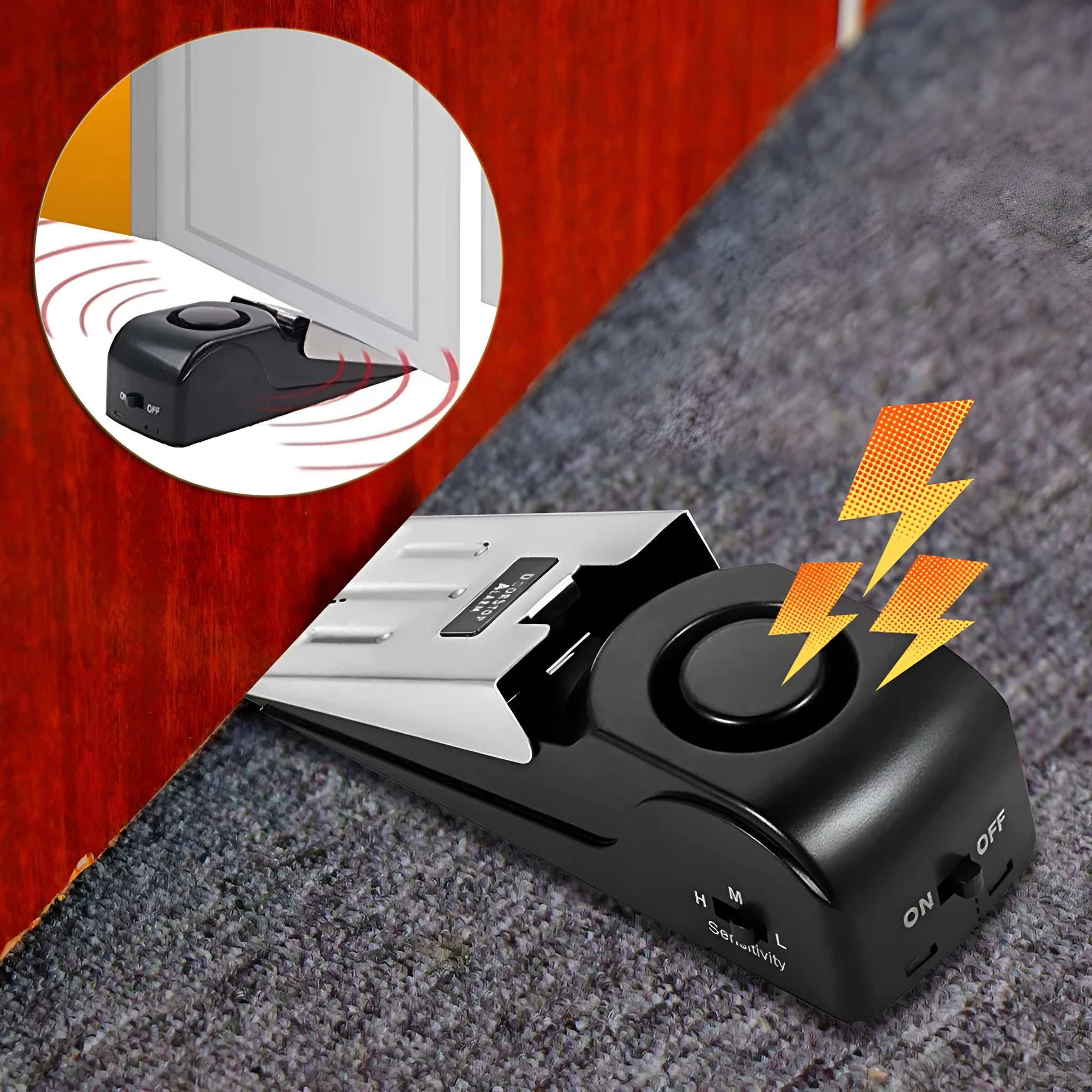 Black portable door stop alarm with wedge shape and stainless steel cover on a wooden floor.