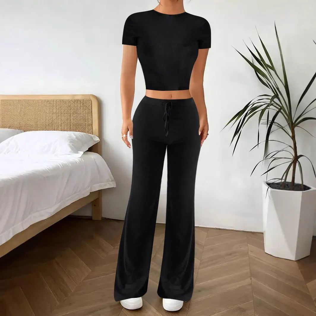 Black polyester two‑piece co‑ordination set with high‑waist trousers and a short‑sleeve t‑shirt.