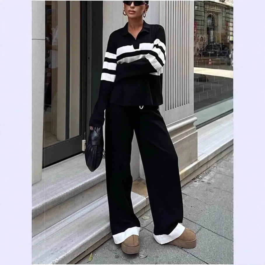 Women's black and white striped polo collar knitted top with matching trousers, a casual two-piece set.