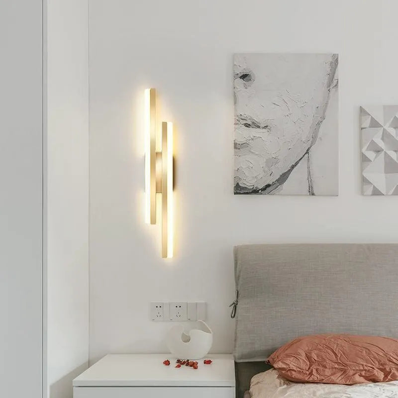 Scandinavian minimalist acrylic LED wall light in black or gold finish on a modern interior wall.