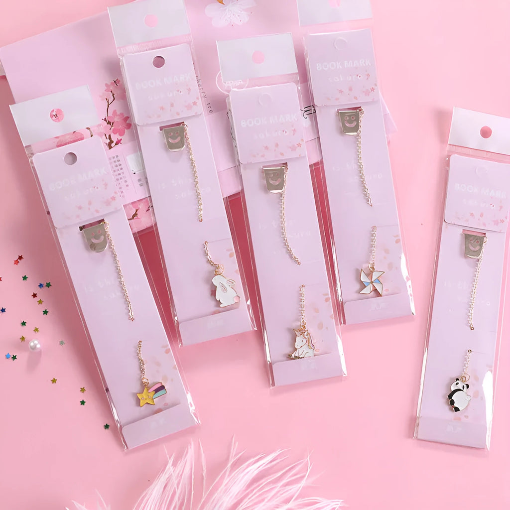 Cartoon-themed alloy metal bookmark charm on a book page.