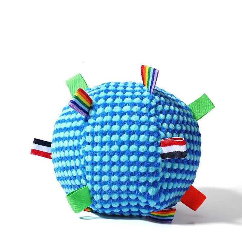 Blue and yellow textured rubber dog ball with holey lattice design, 17cm in diameter, on a wooden floor.