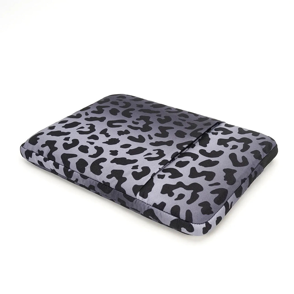 Leopard print laptop sleeve protecting 13-inch to 16-inch computers with waterproof polyester construction