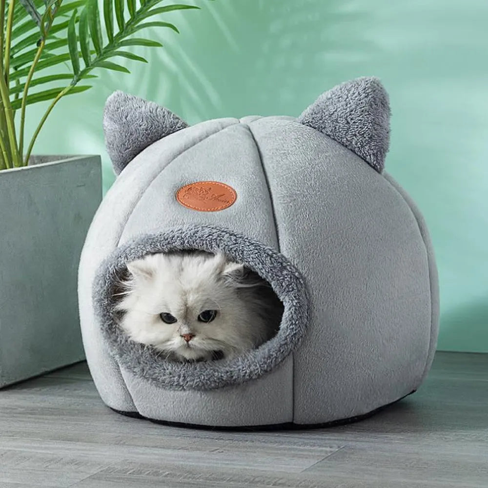 Grey enclosed cat sofa bed with a round entrance hole, showing a soft plush interior and removable cushion.