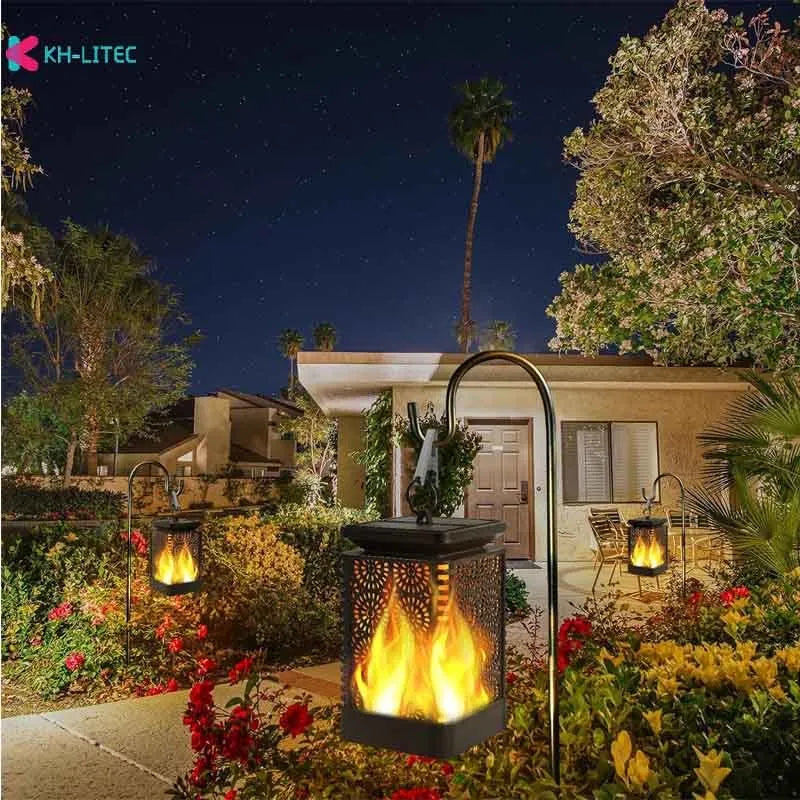 Set of four black solar-powered garden lanterns with flickering flame LED lights.