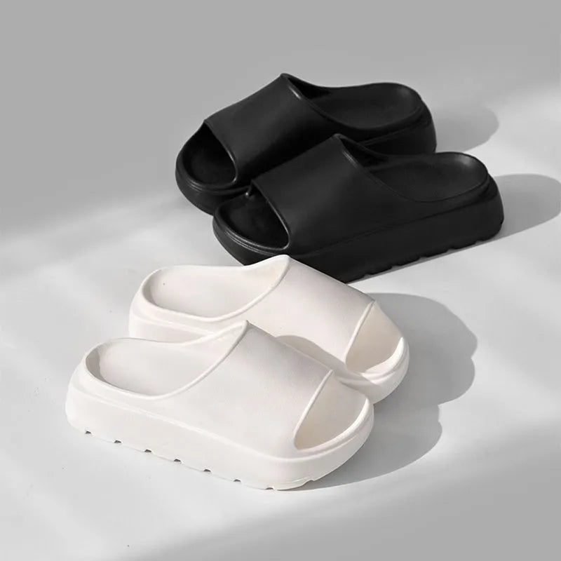 Women's beige fish mouth slippers with a thick EVA sole on a bathroom tile floor.