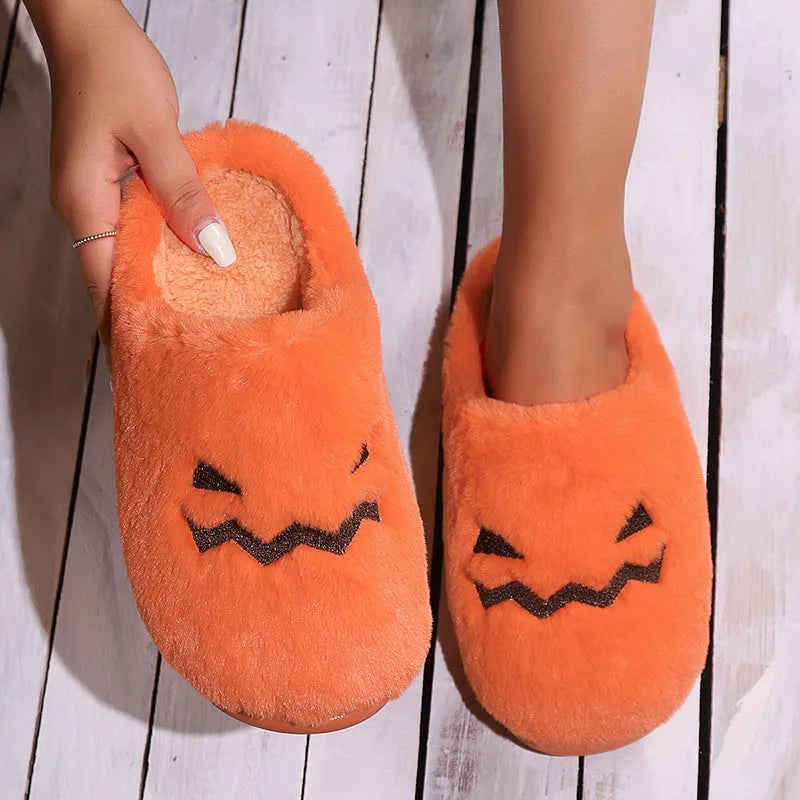 Orange Halloween pumpkin-themed plush indoor slippers with a non-slip PVC sole.