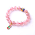 Pink strawberry quartz bracelet with Chinese Ruyi charms and engraved text on wrist