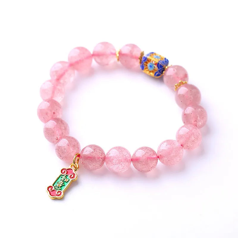 Pink strawberry quartz bracelet with Chinese Ruyi charms and engraved text on wrist