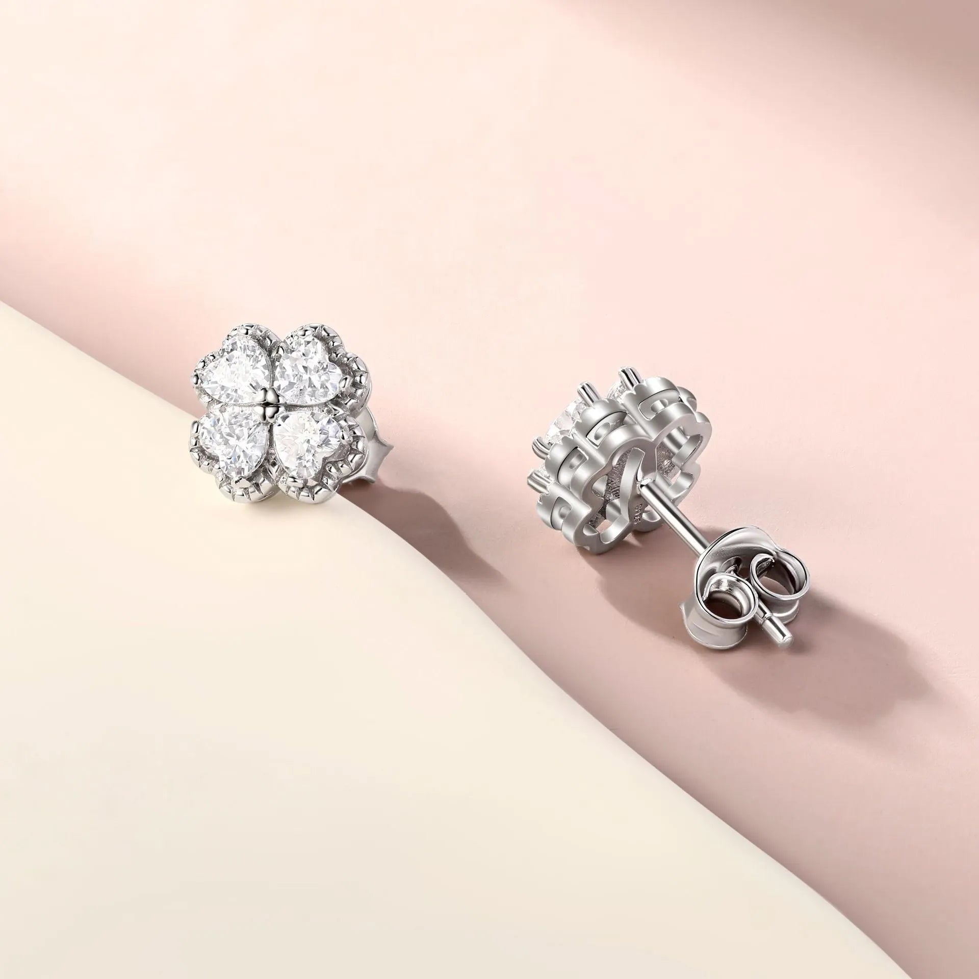 Close-up of women's heart-shaped zircon earrings in 925 silver with a white gold colour finish.