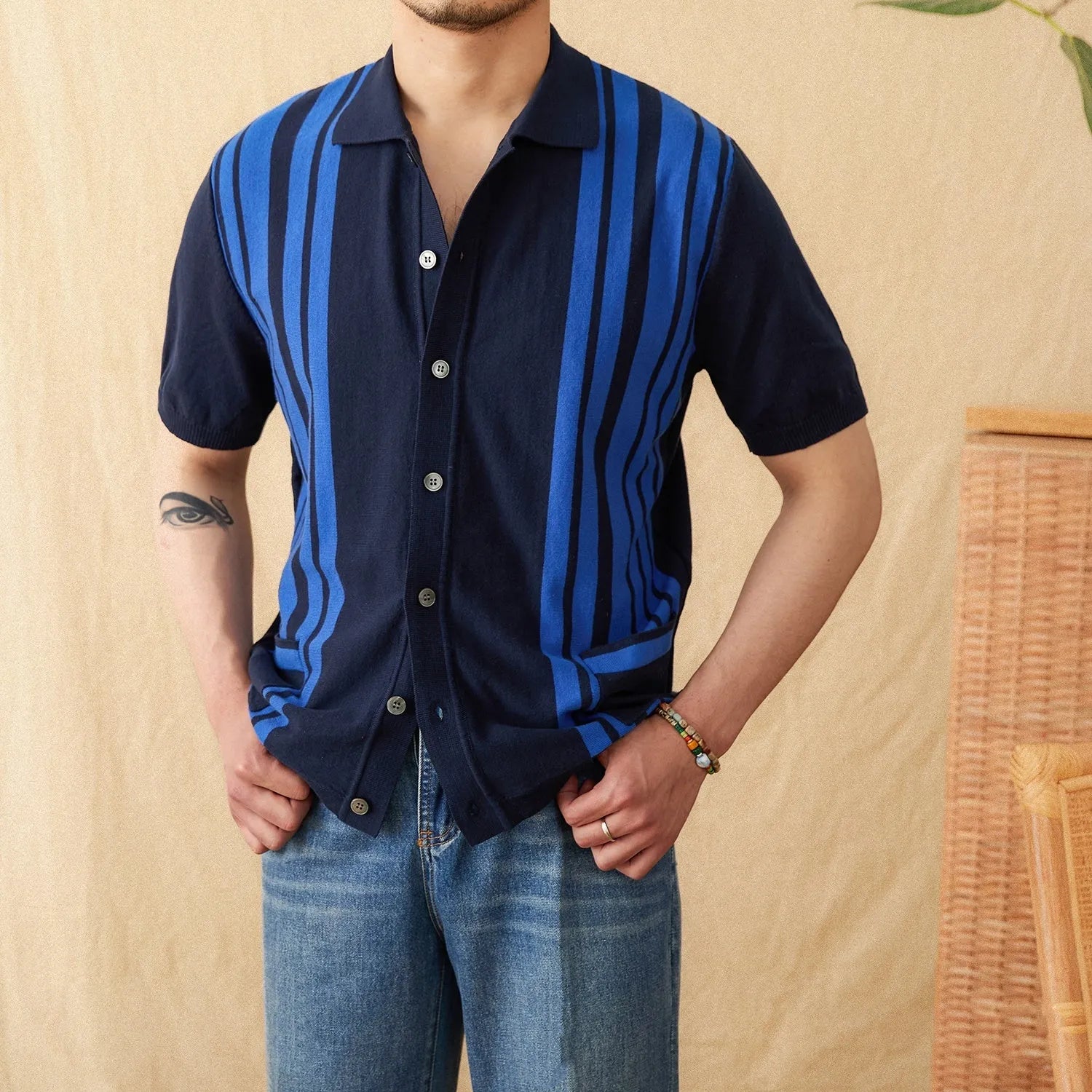 Short-sleeved striped knit polo cardigan with a lapel collar in a light blue colour.
