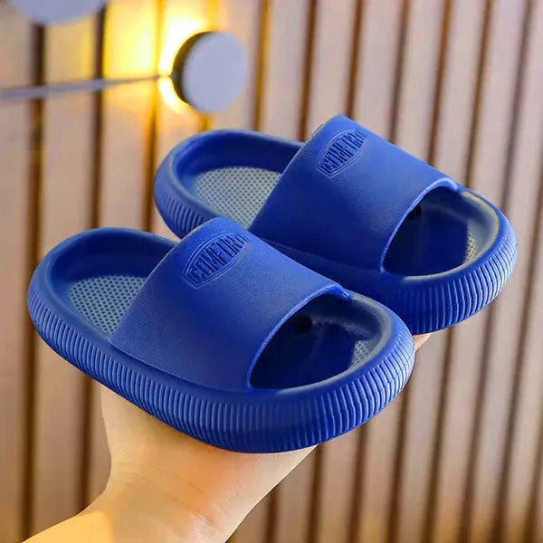 Children's mixed colour EVA slippers with textured non-slip soles and 1.5cm thick cushioning.