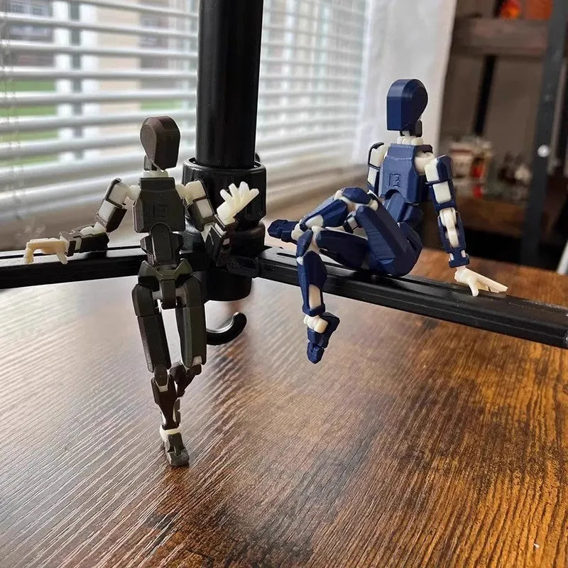 3D printed multi-jointed robot action figure model with movable joints on a desk.