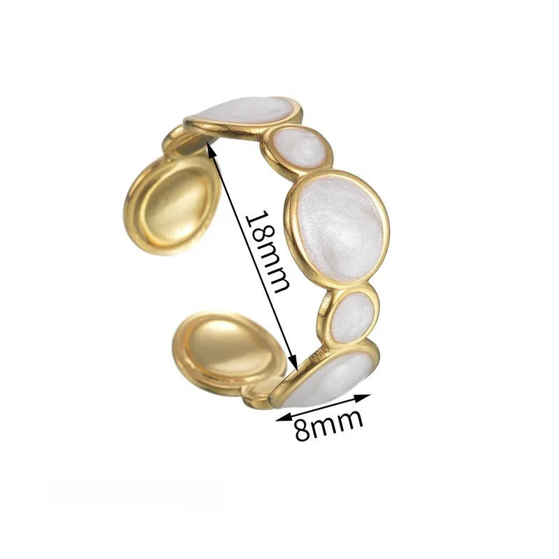 Adjustable geometric ring in stainless steel with a light luxury electroplated finish on a grey background.