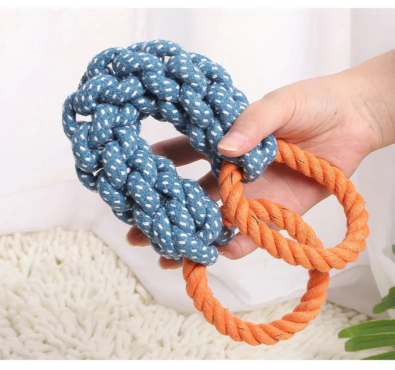 Blue braided cotton rope dog toy shaped like a bone with two rings, on a white background.