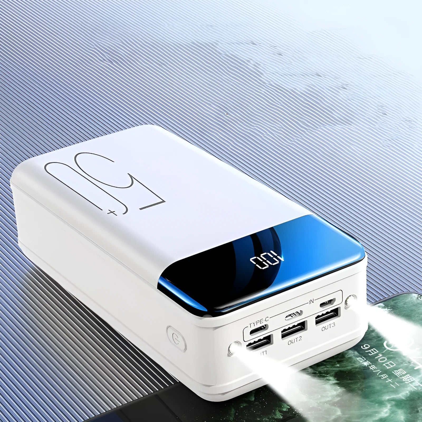 Black and white 50000mAh power bank showing three USB output ports and its large form factor.