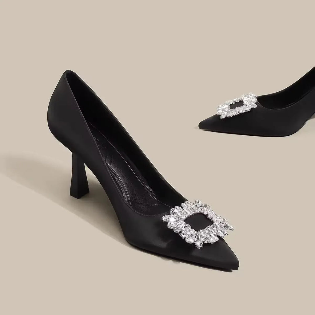 Women's creamy-white pointed-toe stiletto high heels on a plain background.