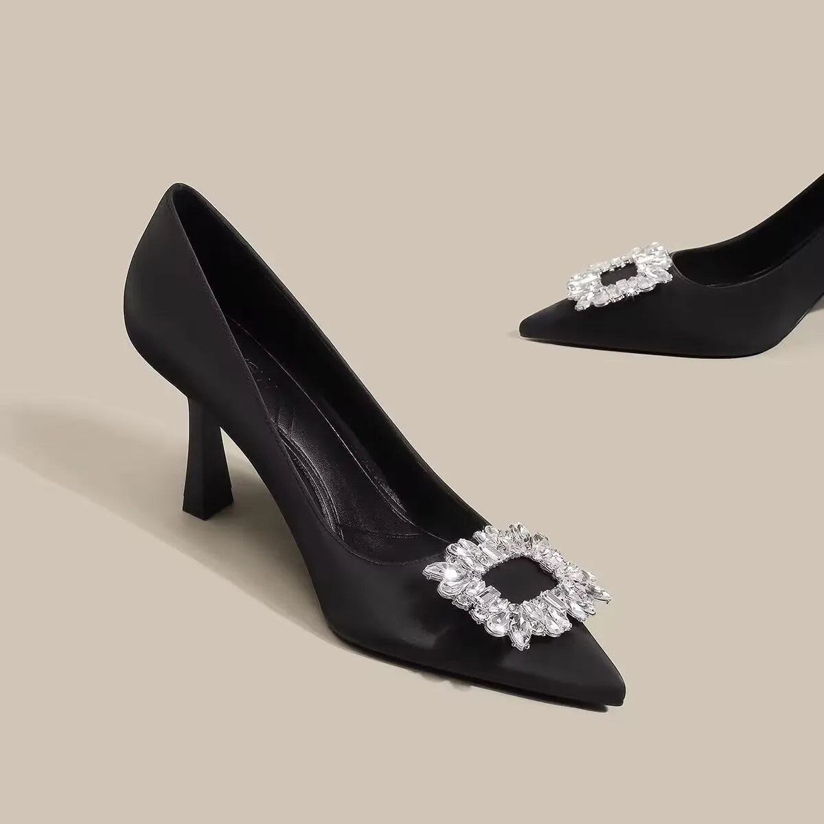 Women's creamy-white pointed-toe stiletto high heels on a plain background.