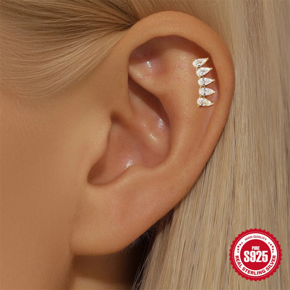 S925 sterling silver geometric star-shaped earrings with a moon and diamond detail in a gold tone.
