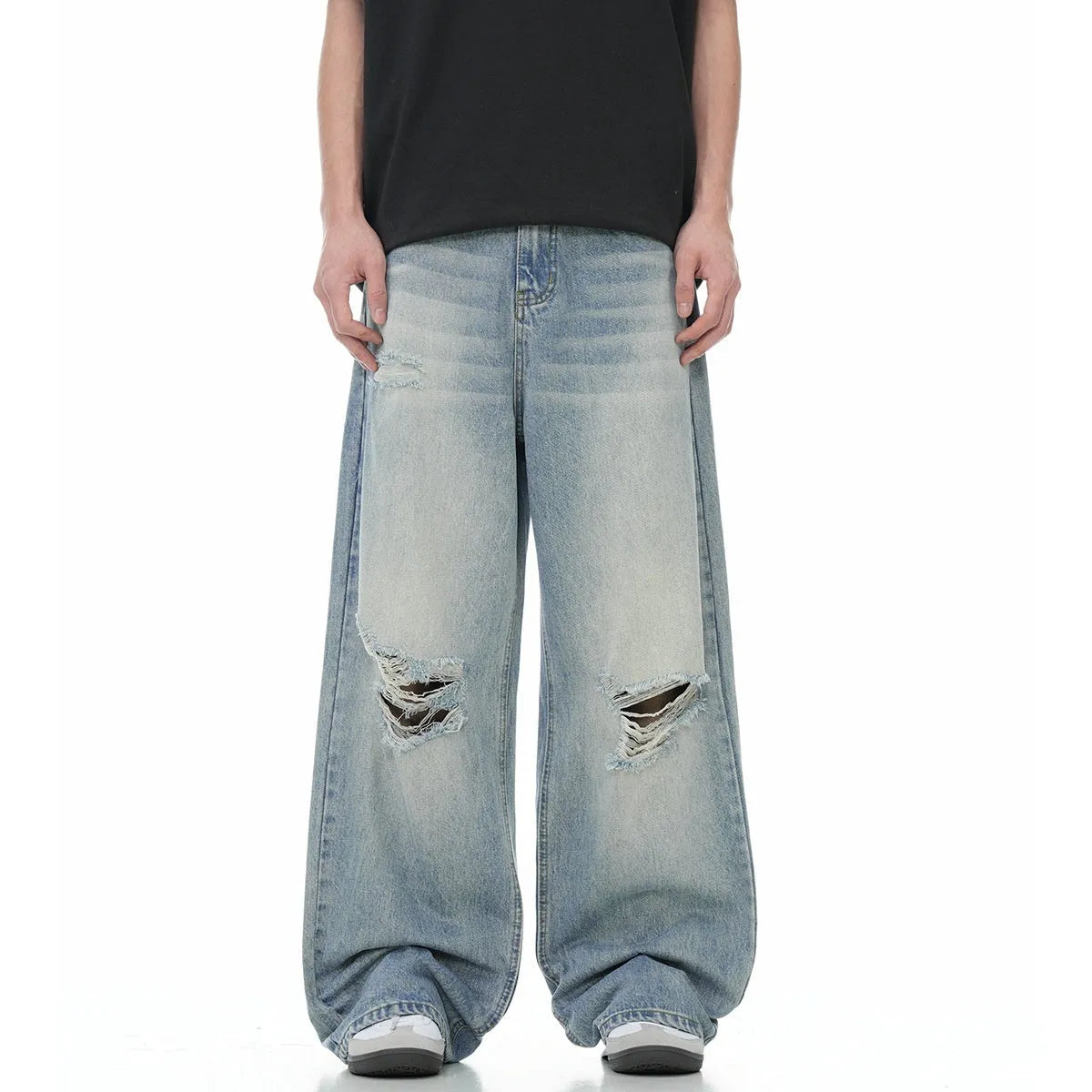 Blue men's straight-leg jeans with ripped details and a zip fly on a neutral background.