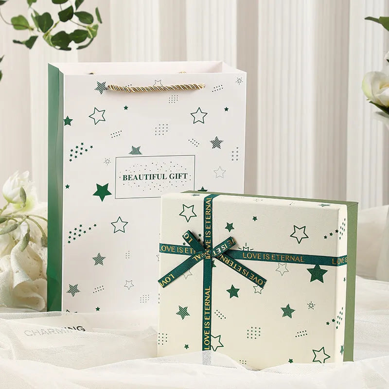 Cardboard gift box with bow in red, green, and pink, multiple sizes for gifts