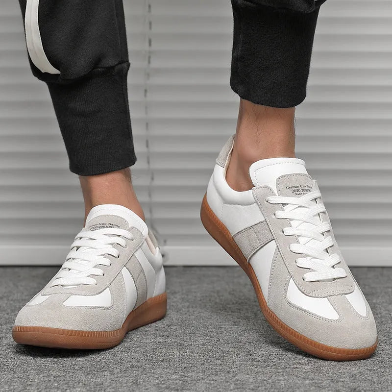 White Japanese-style retro low-top sneakers with mesh lining and a flat rubber sole on a plain background.