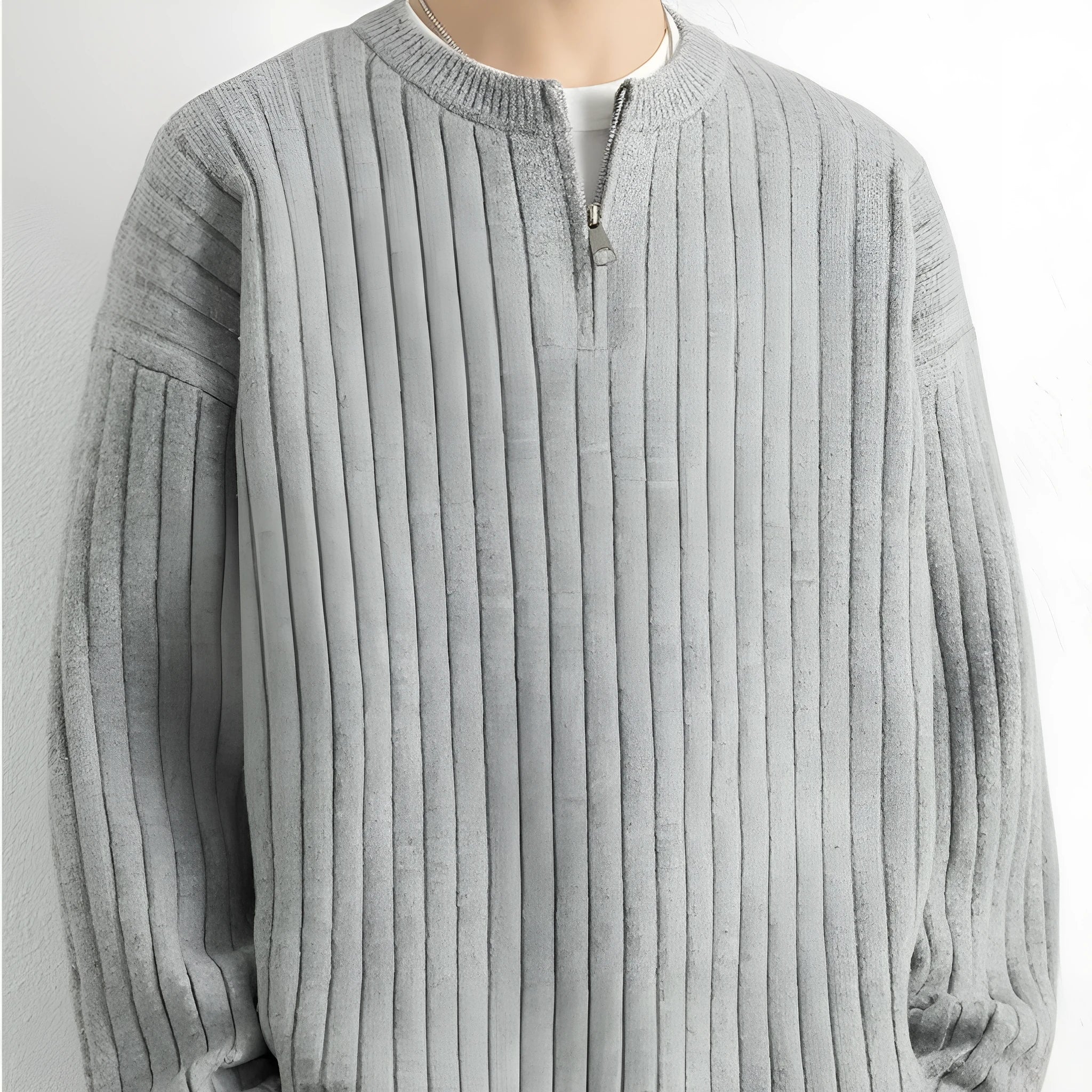 A grey men's textured knit half-zip pullover sweater on a hanger, showing the loose fit and long sleeves.