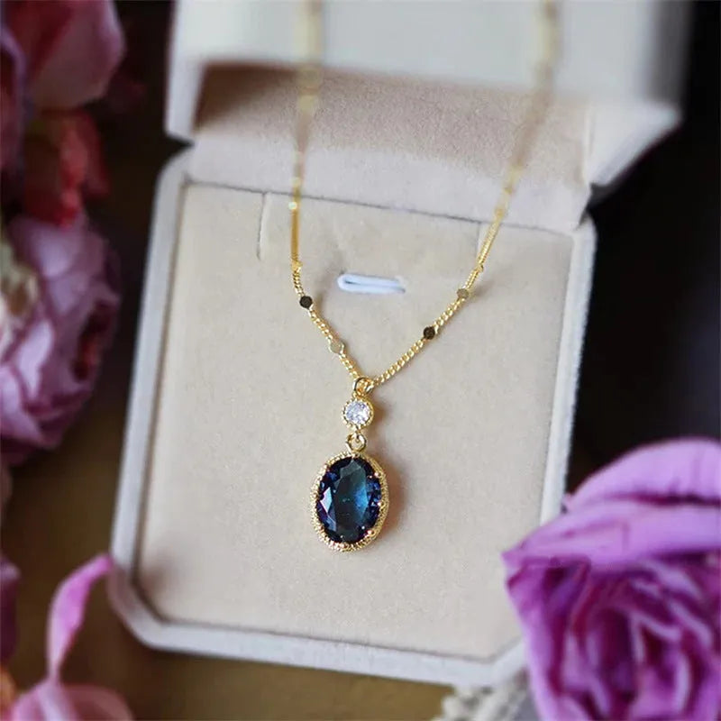 A gold-coloured geometric pendant on a copper chain necklace.