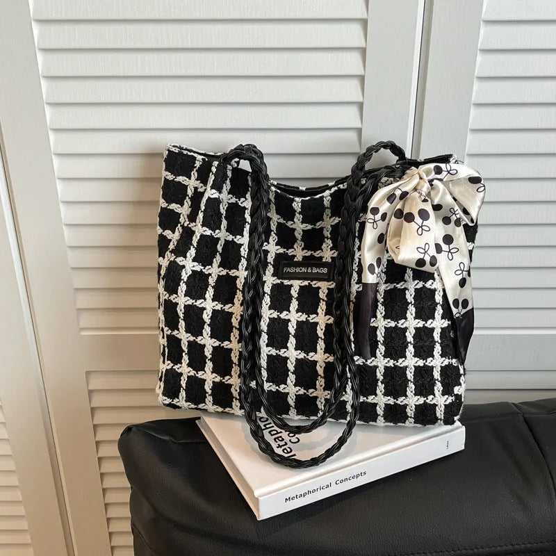 Black woven wool shoulder bag with horizontal square design and internal organisation compartments