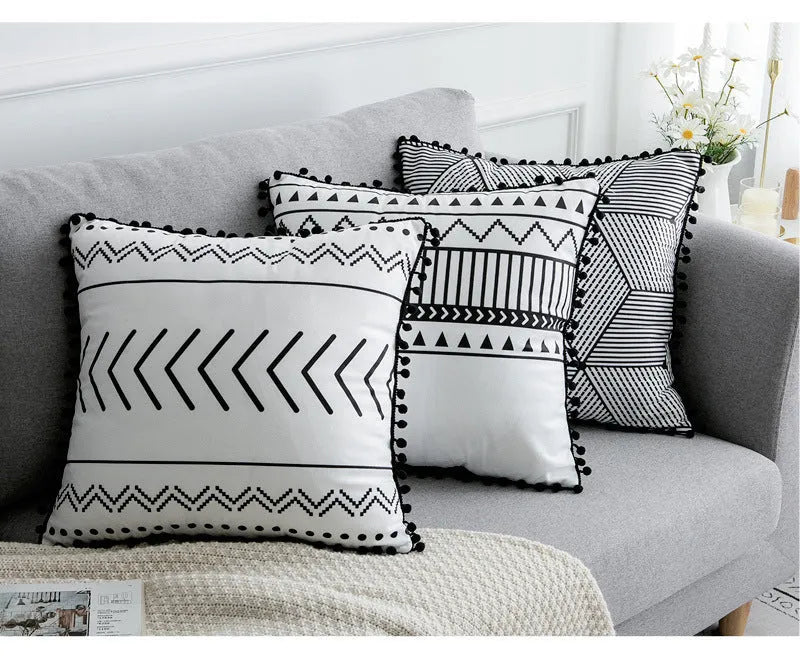 Bohemian national style polyester cushion cover in light grey on a sofa.