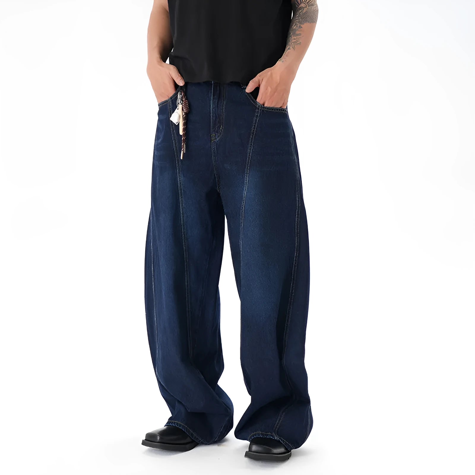 Dark blue washed distressed wide leg machete jeans showing denim fabric texture and wide leg silhouette