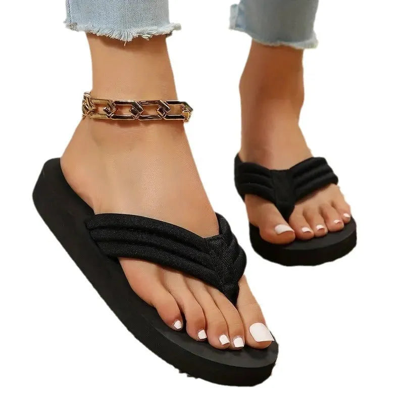 Black women's flat slippers with a cotton upper, ribbon detail, and a textured EVA sole.