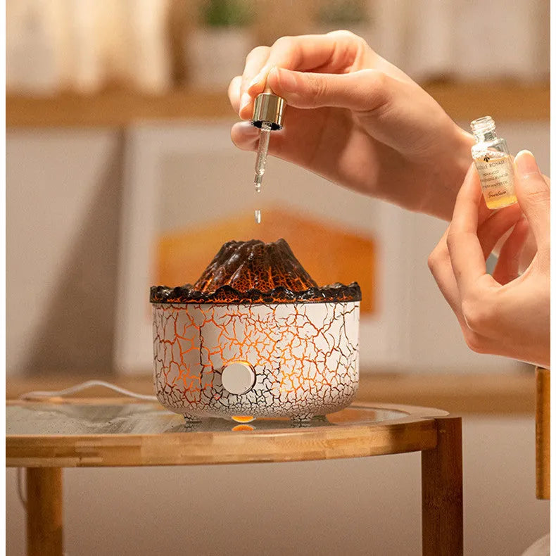 Column-shaped volcano humidifier diffuser emitting mist with red and orange LED flame effect