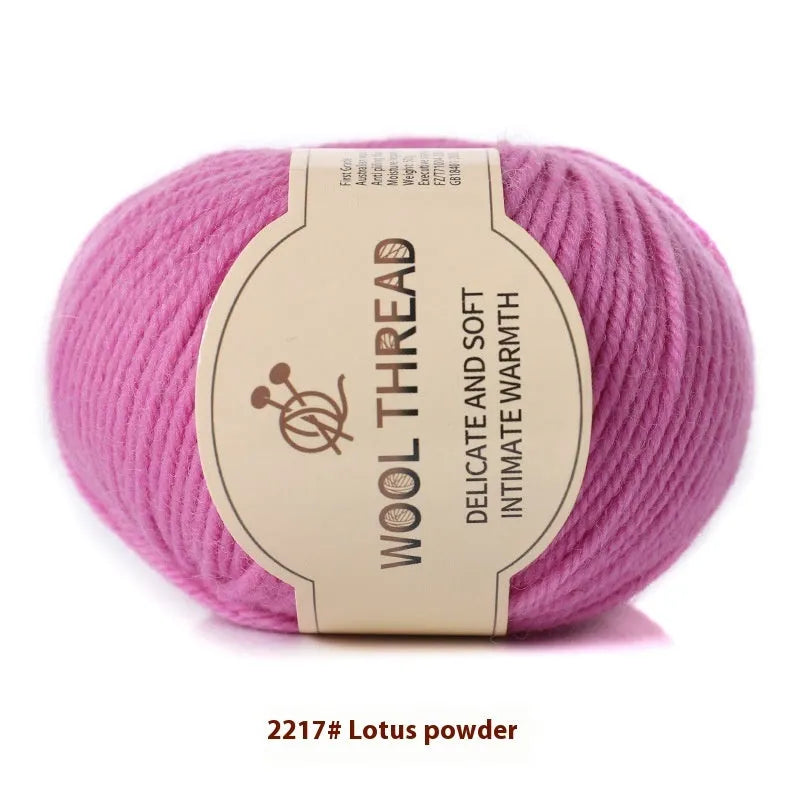 One roll of beige domestic wool hand-knitting yarn for size 10 needles next to knitting needles.