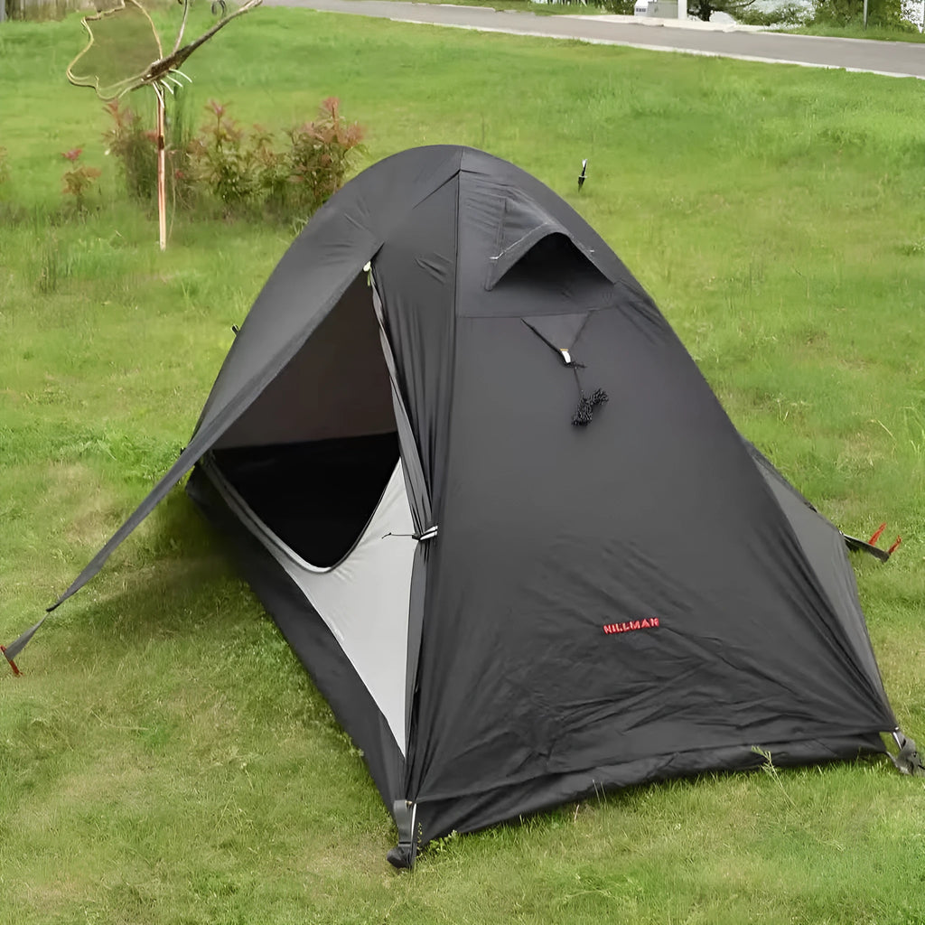 Single-person double-skin hiking tent in orange with aluminium poles, shown pitched in a field.