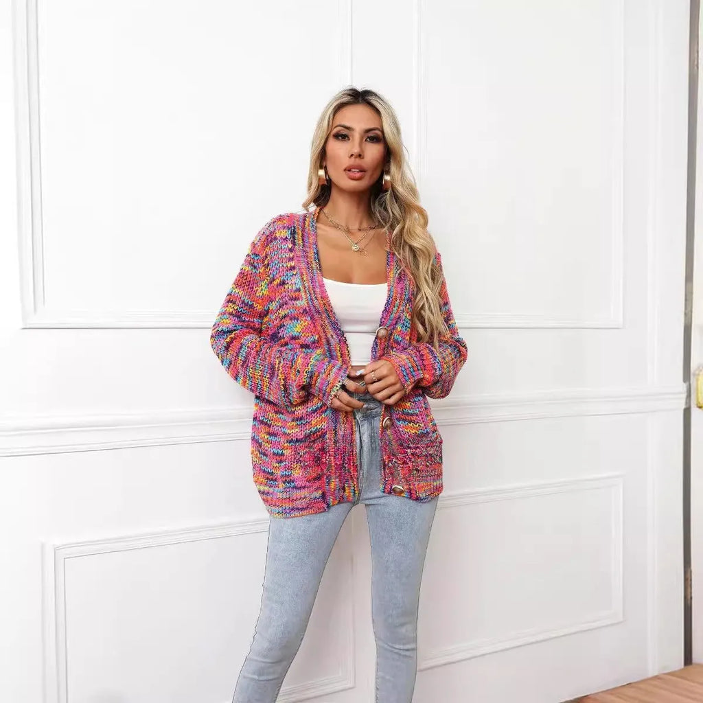 Rose red loose fit short cardigan coat with rainbow striped pattern on a hanger.