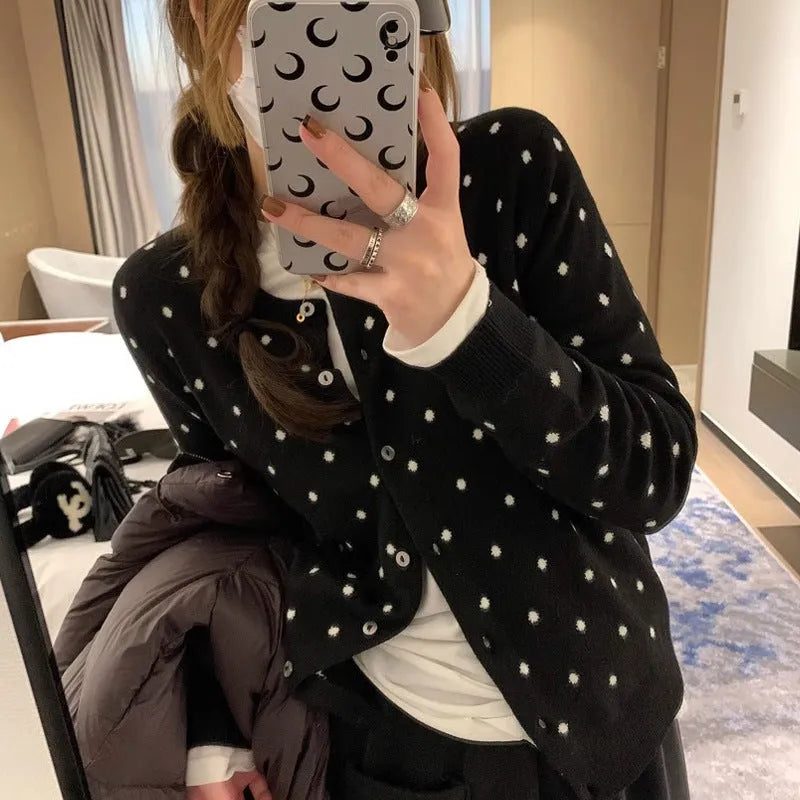 Women's grey dot print knitted cardigan with white crocheted flower detail on sleeve