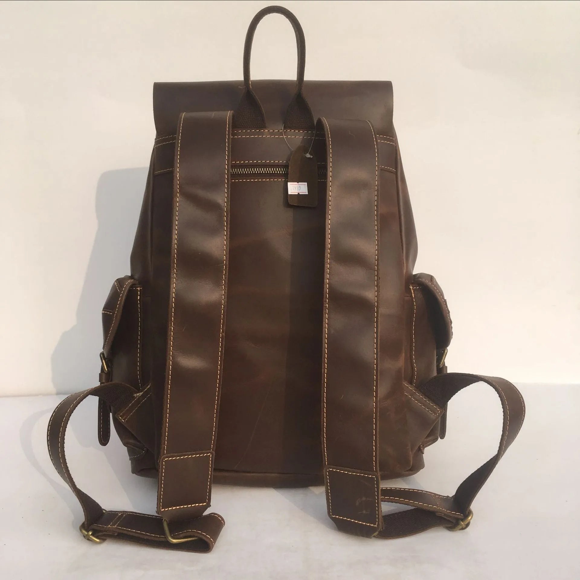 Brown coffee genuine leather men's backpack with air cushion shoulder straps showing first layer cowhide texture