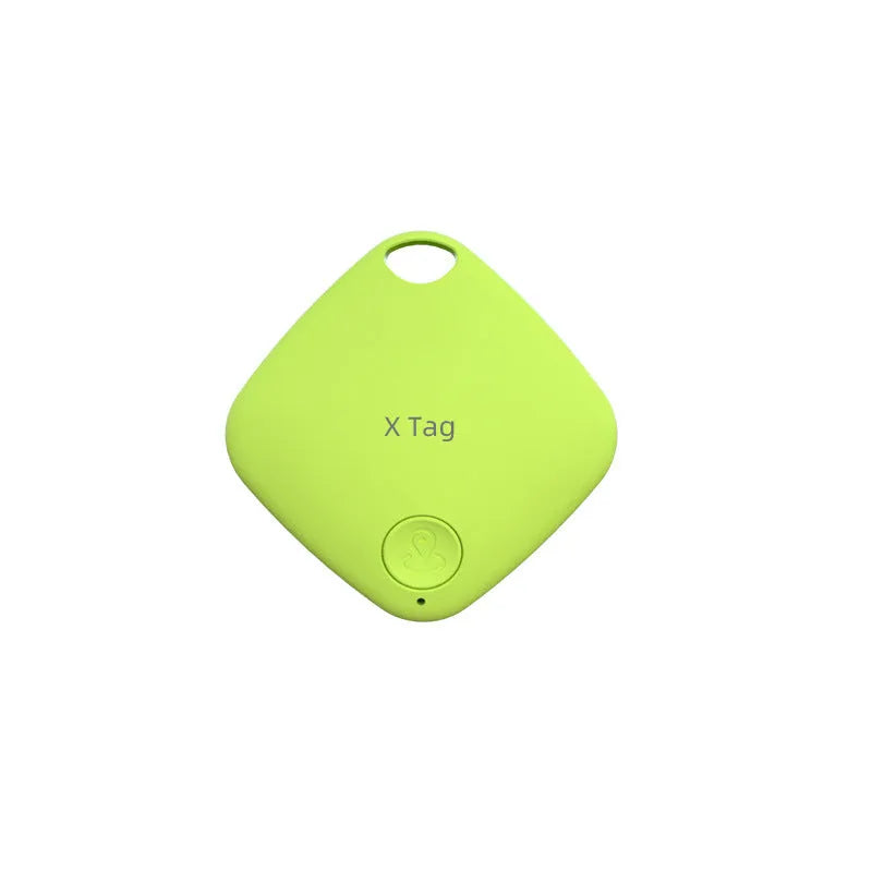Small black Bluetooth key finder tracker on a keyring next to a smartphone showing location app.