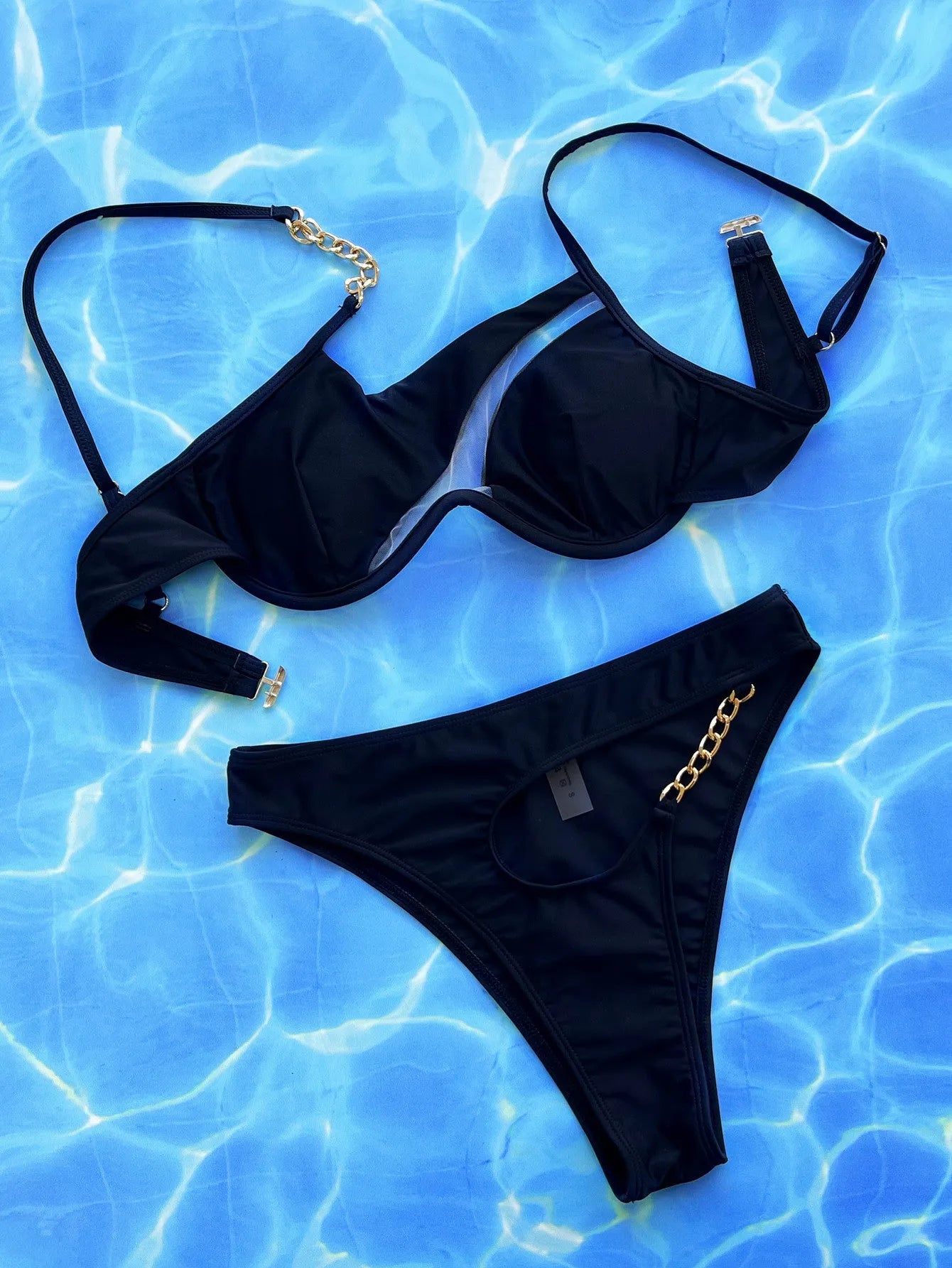 Black women's one-piece swimsuit with a hollow split front and halter neckline.