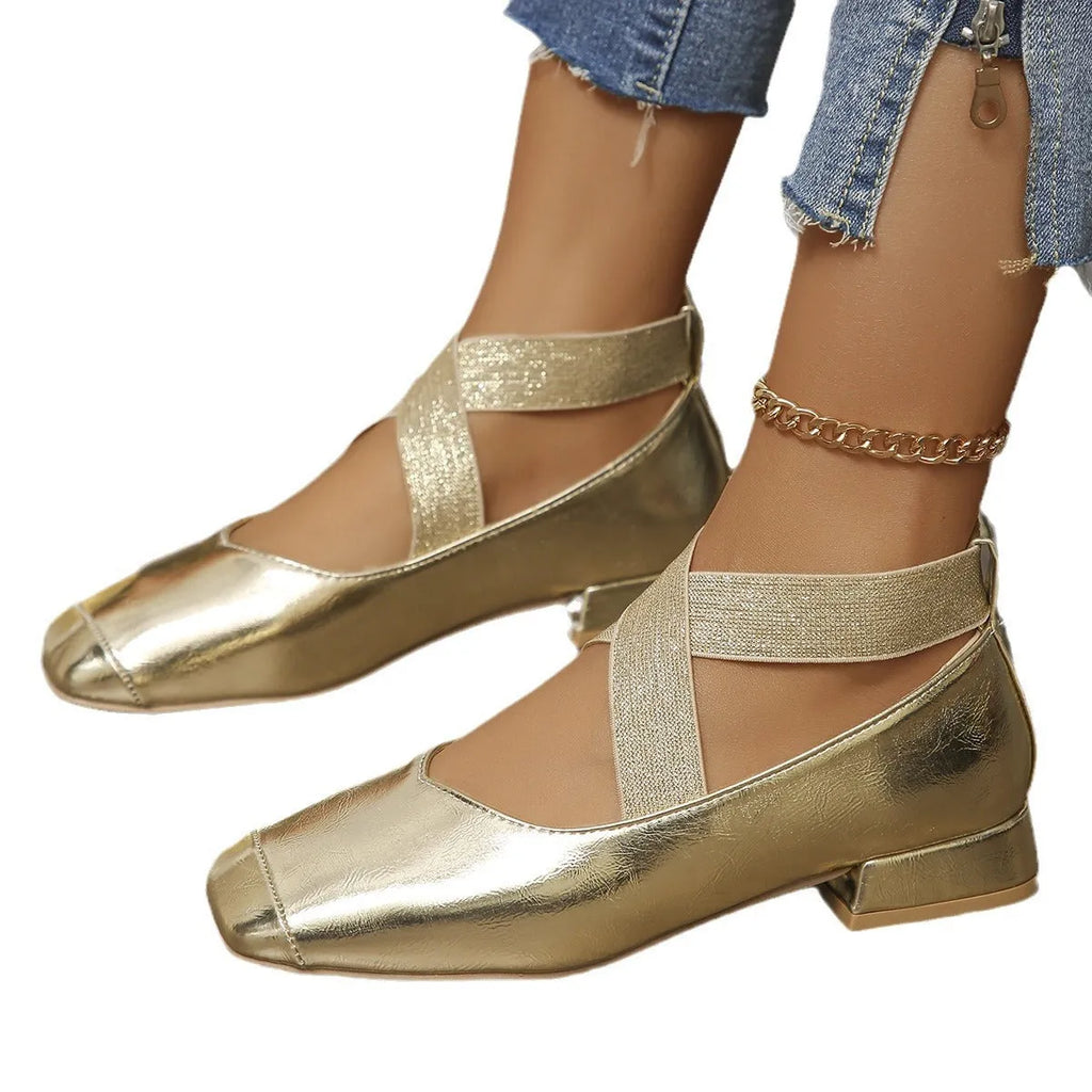 Gold slip-on evening pumps with a square toe and low heel on a plain background.