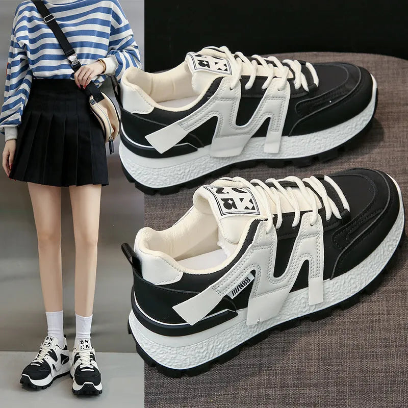 Low top running sneaker in white with round toe and lace-up front on rubber sole