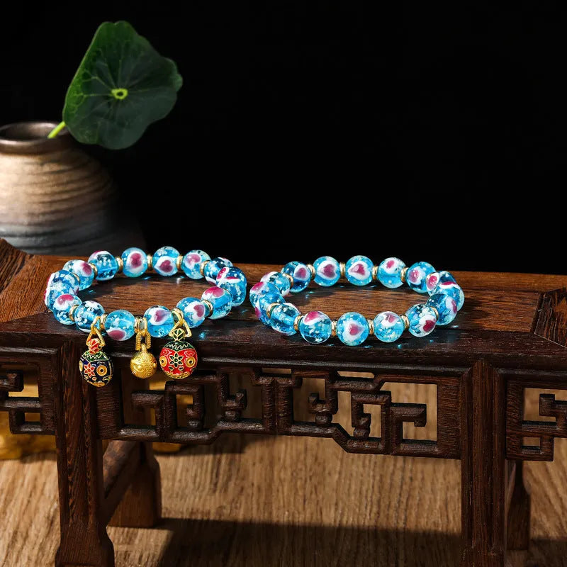 Handmade glass bracelet with swallowing gold beast design on heart-shaped 10mm beads