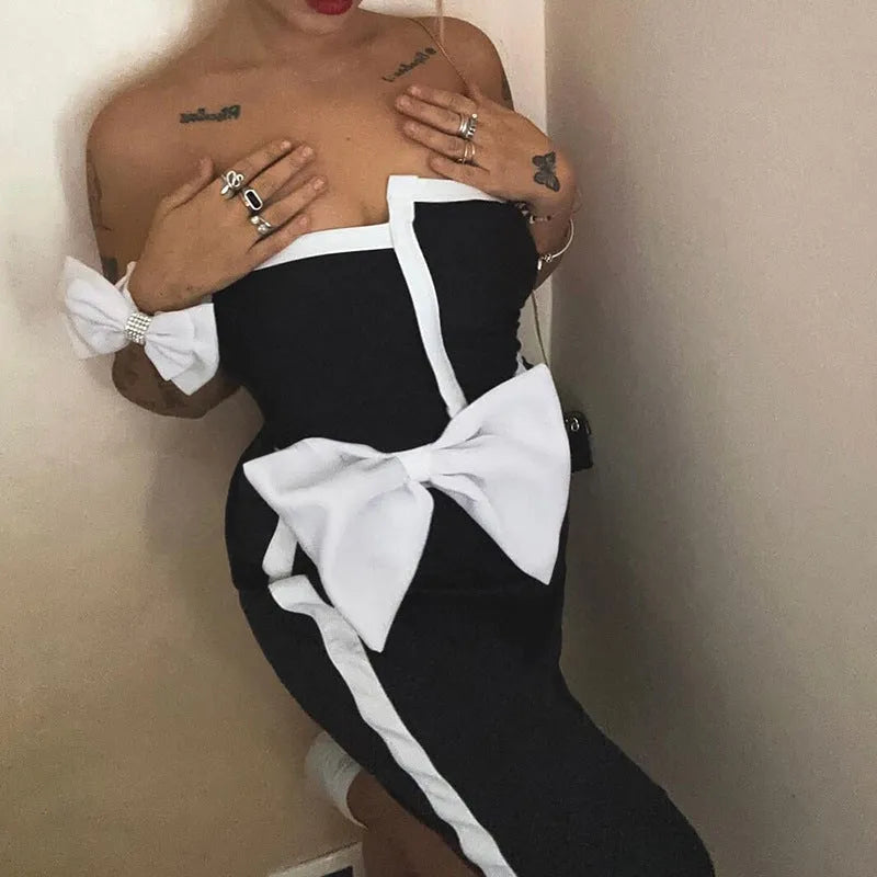 Black and white colour-block women's one-piece swimsuit with an asymmetrical bow on the tube top.